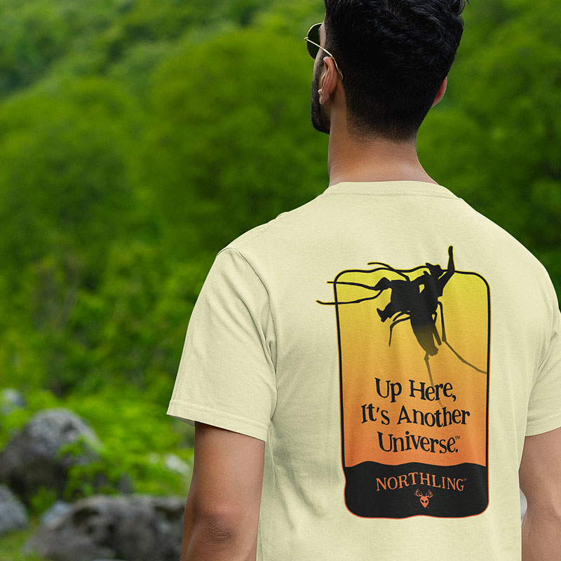 Yellow t-shirt from outdoor brand Northling with cowboy riding mosquito design.